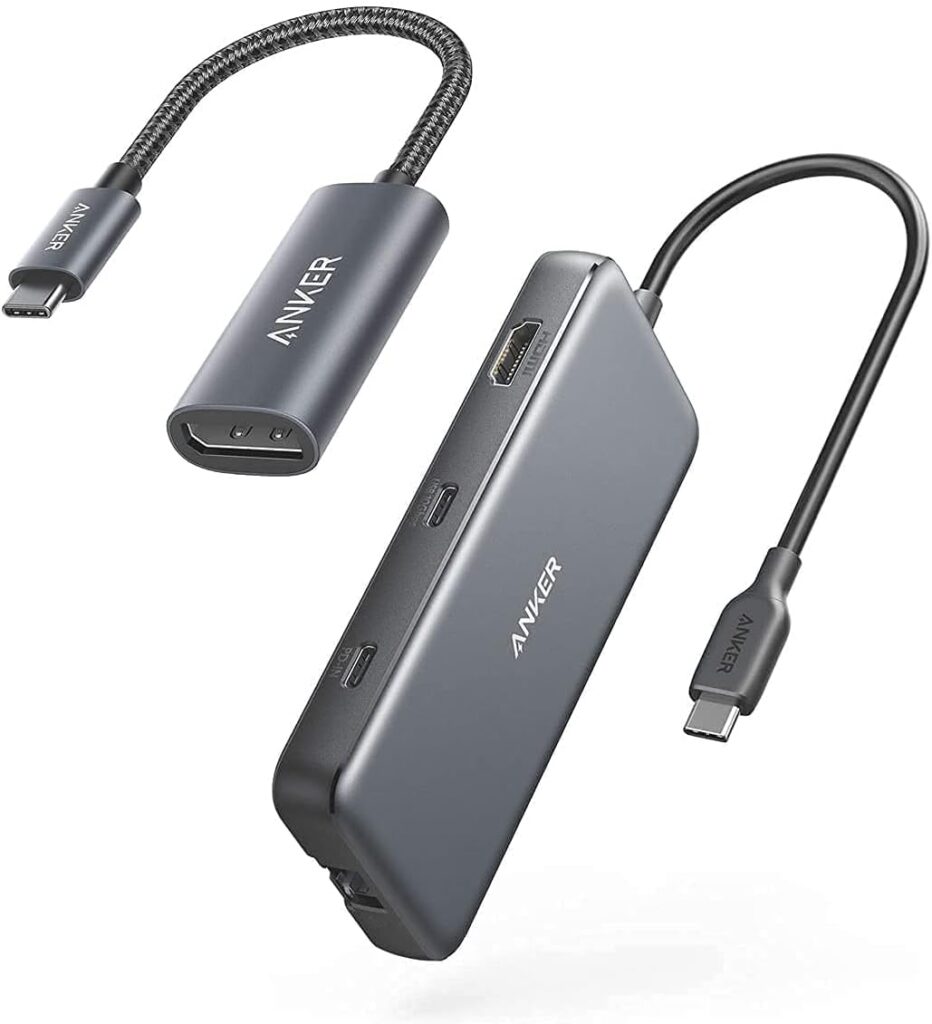 Anker 8-in-1 hub showing multiple ports including HDMI, USB-A, and SD card slot on a laptop desk setup”